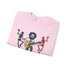 Light pink crewneck sweatshirt folded, featuring band graphic print