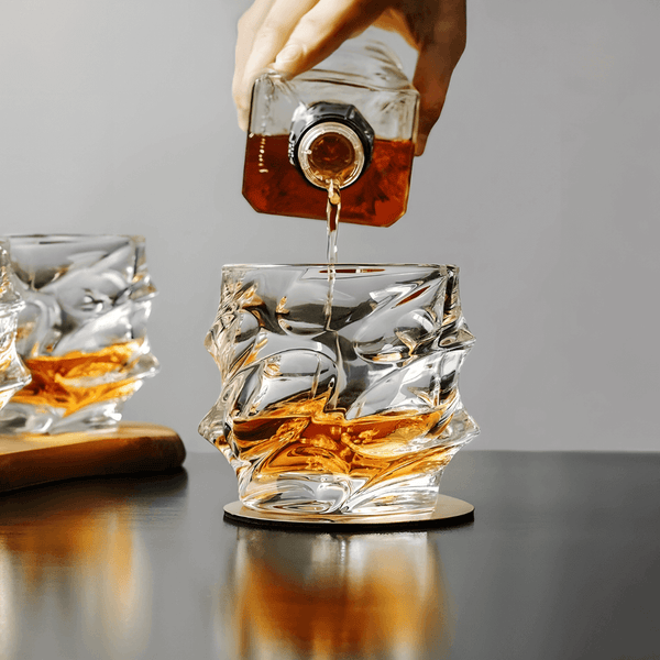 Japanese crystal whisky glass with textured cut sides, amber whisky being poured in