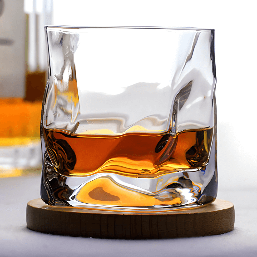 Hoshi Japanese crystal whisky glass with amber whisky on round wooden coaster
