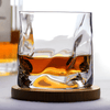 Hoshi Japanese crystal whisky glass with amber whisky on round wooden coaster