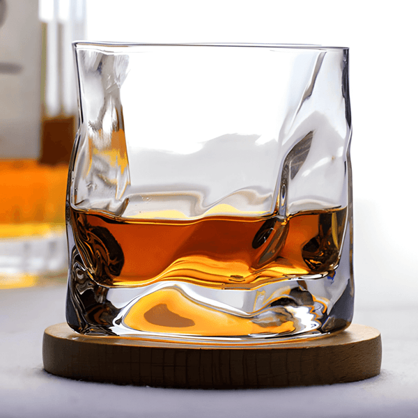 Hoshi Japanese crystal whisky glass with amber whisky on round wooden coaster