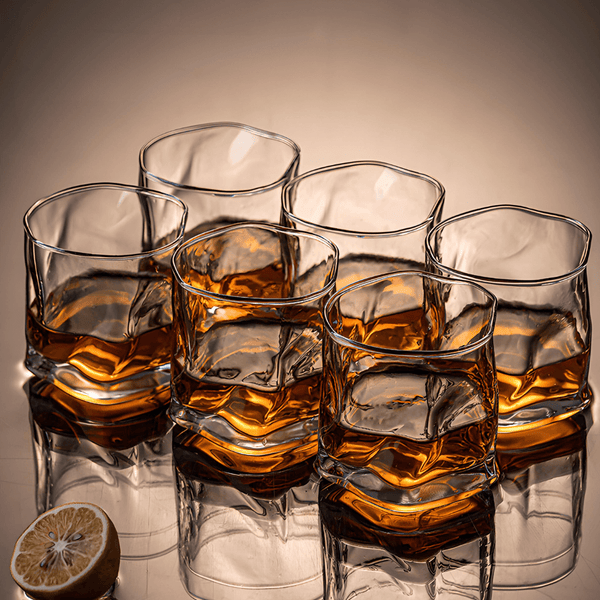 Set of Hoshi crystal whisky glasses filled with amber whisky, stacked arrangement