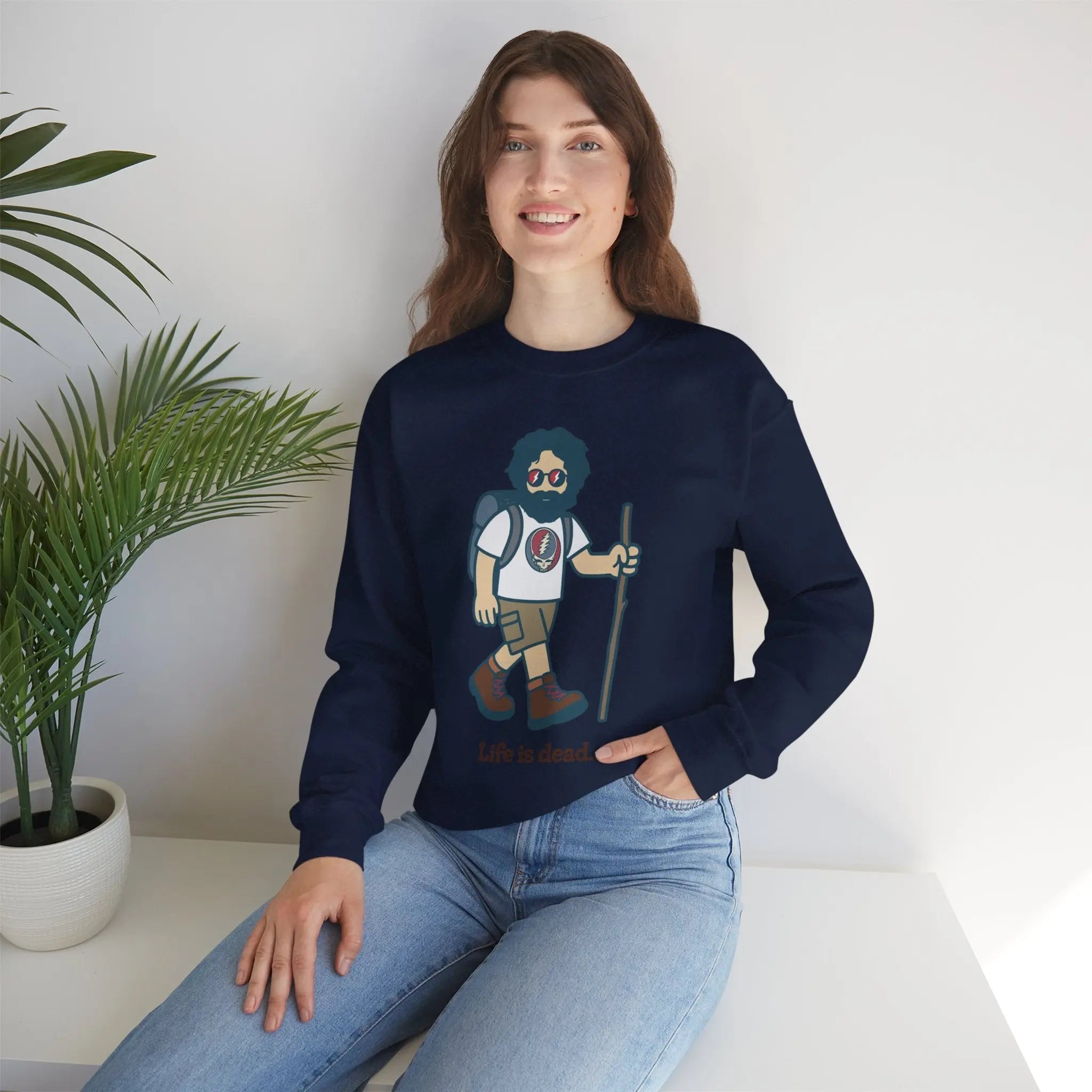 Navy crewneck sweatshirt with hiker character graphic, worn with blue jeans