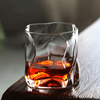 Hoshi Japanese crystal whisky glass with amber whisky on dark wood and textured cloth