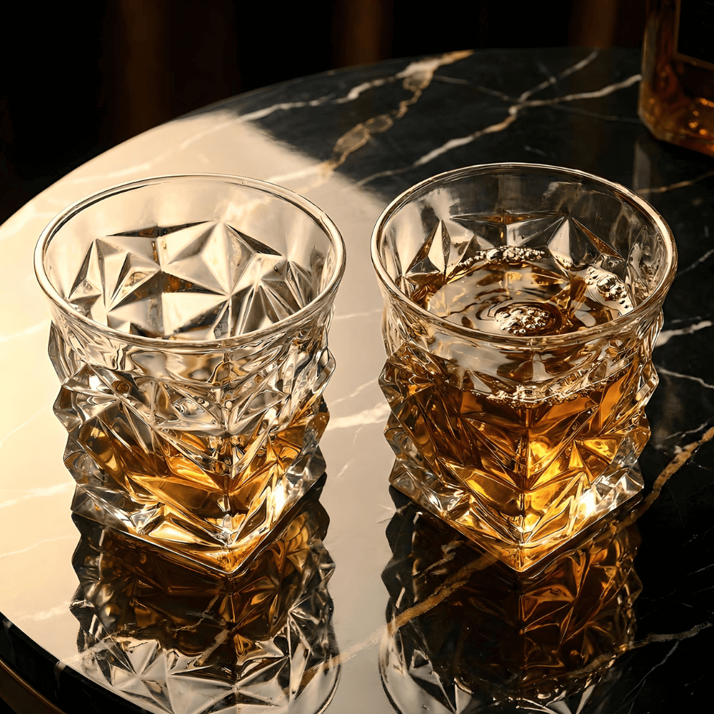 Two crystal whisky tumblers with faceted star-cut sides