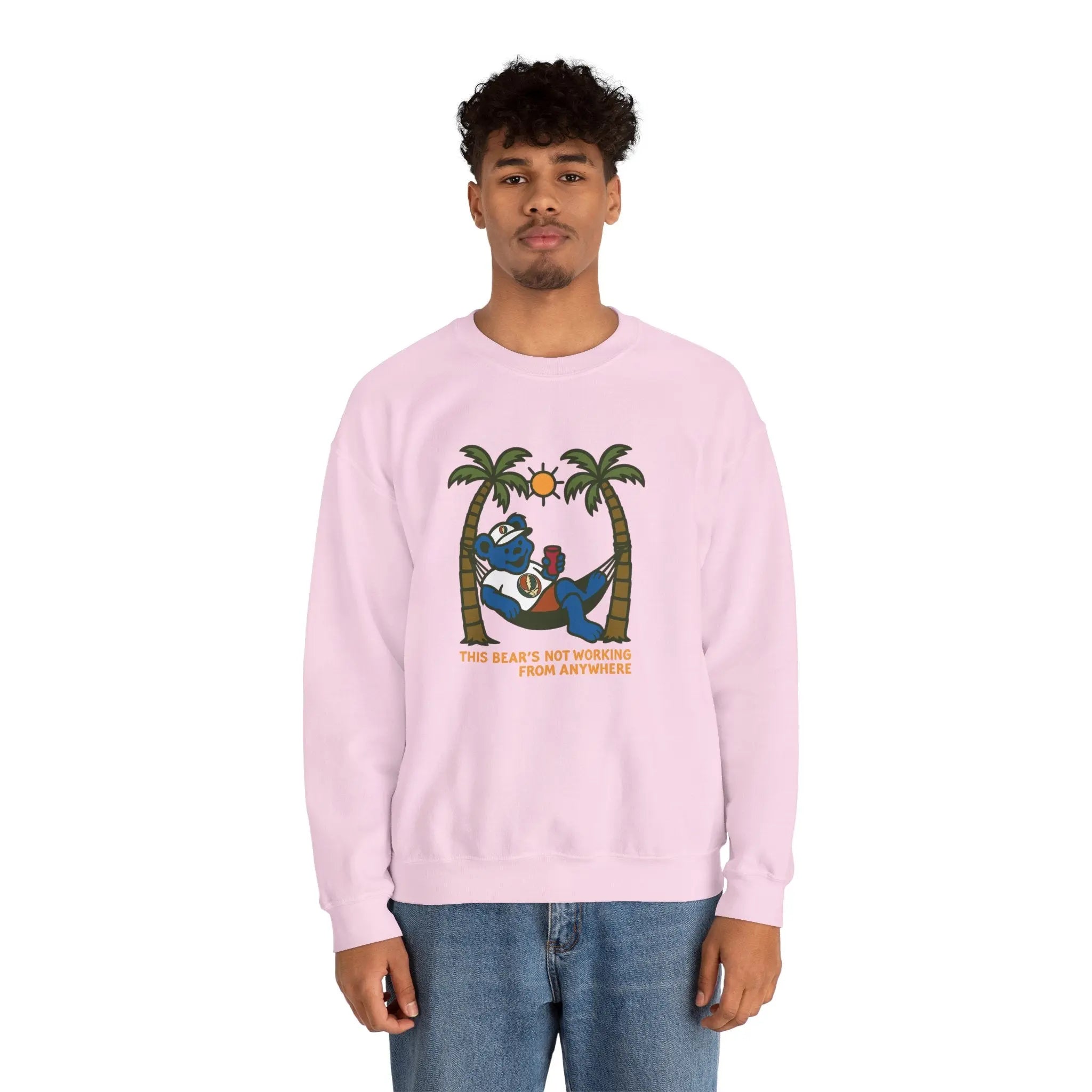 Light pink crewneck sweatshirt on model, front bear graphic with palms