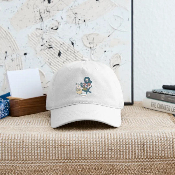 White dad hat, front panel featuring embroidered cartoon skull holding a coffee cup
