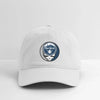 White dad hat with New York Yankees circular logo patch, curved brim.