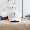 White dad hat with embroidered golf character logo patch and curved brim