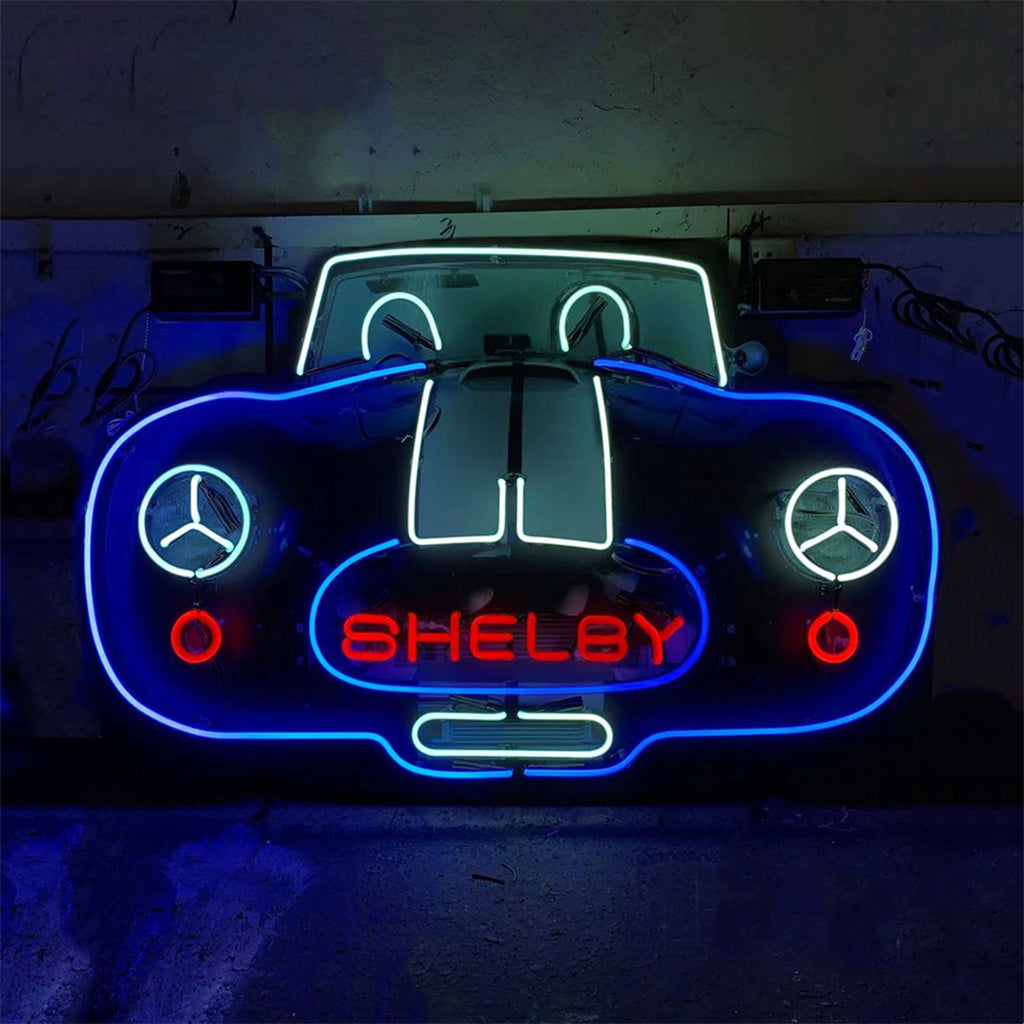 Neon car sign showing blue outline, red side lights, SHELBY, and Mercedes logos