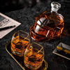 Football-shaped whiskey decanter with amber tumblers on a tray
