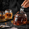 Football-shaped whiskey decanter with amber tumblers and poured glasses