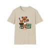 Beige T-shirt with cartoon bear grilling graphic and small text at bottom