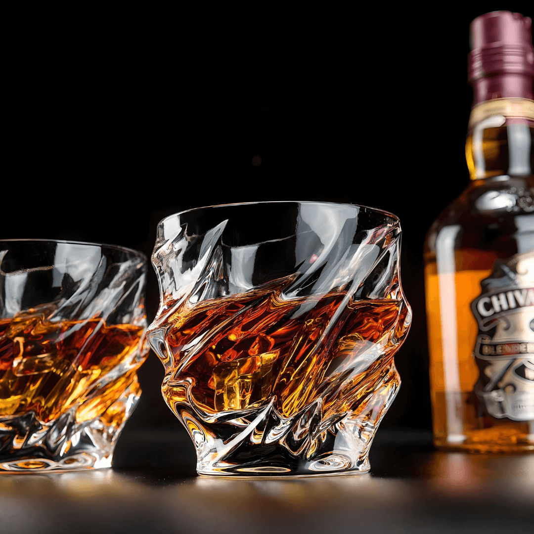 Crystal whisky glass with faceted wave pattern and thick rounded rim, amber reflections