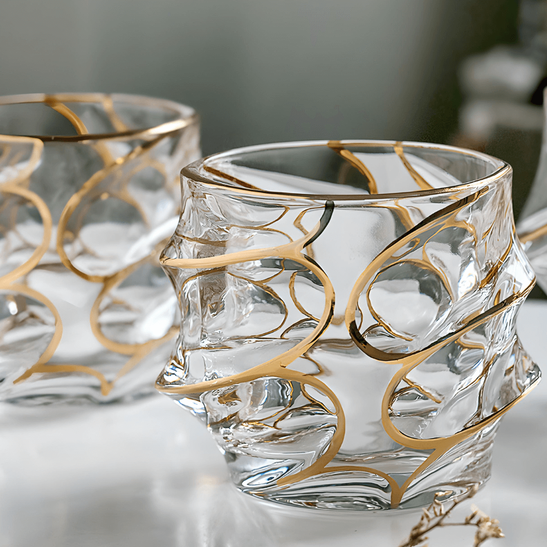 Clear crystal whisky glass with gold swirl line design, thick faceted sides