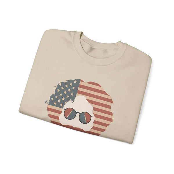 Sand crewneck sweatshirt with American flag face graphic and sunglasses, folded