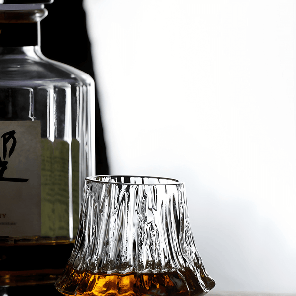 Japanese crystal whisky glass with fluted sides, amber whisky pooled at the base