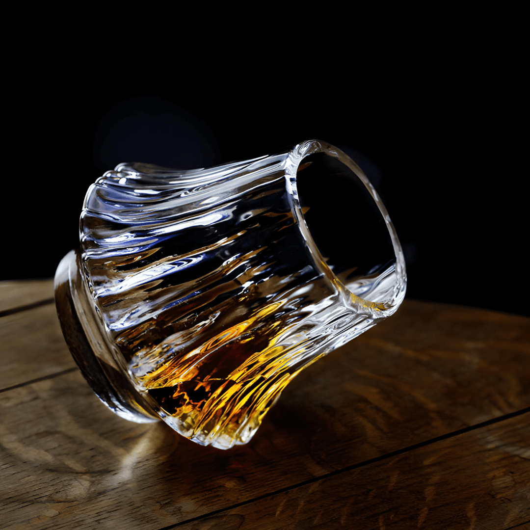 Japanese crystal whisky glass with curved fluted sides, amber liquid visible