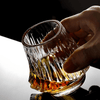 Japanese crystal whisky glass with amber base, hand gripping faceted sides