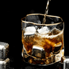 Gold Hoshi whisky glass with gold rim, clear crystal filled with amber drink and ice