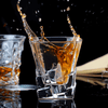 Whisky glass with amber pour, faceted square base and angular walls