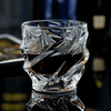 Crystal whisky glass with faceted wave pattern and thick rounded rim
