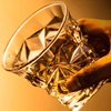 Hand holding a golden faceted Japanese crystal whisky tumbler