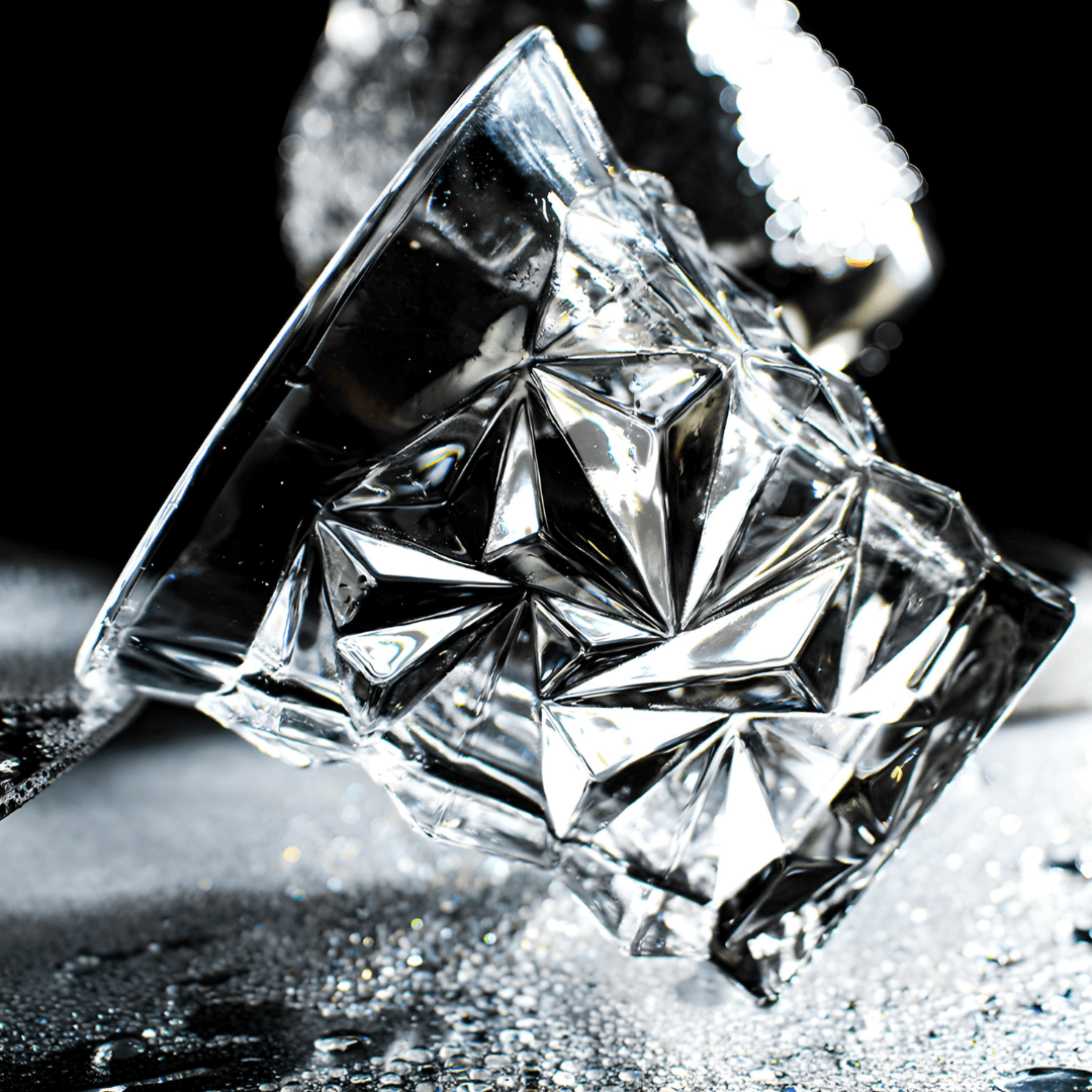 Crystal whisky glass close-up with star-cut facets and sharp geometric pattern