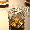 Faceted crystal whisky glass with geometric cut pattern