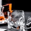 Hoshi Japanese crystal whisky glass with amber whisky, faceted sides and rounded rim