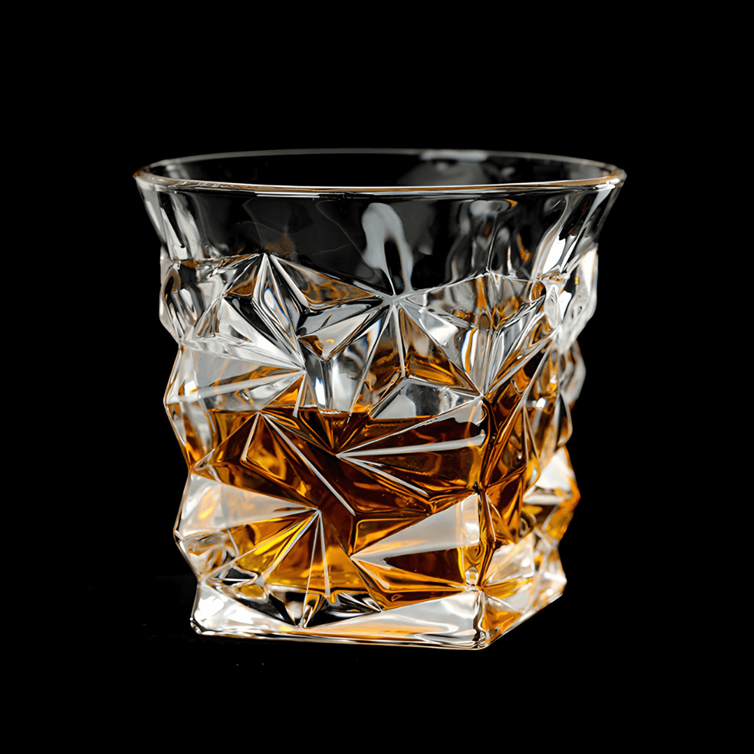Crystal whisky tumbler with faceted geometric design, clear glass with amber tones