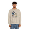Sand crewneck sweatshirt with front cartoon graphic; worn by a male model