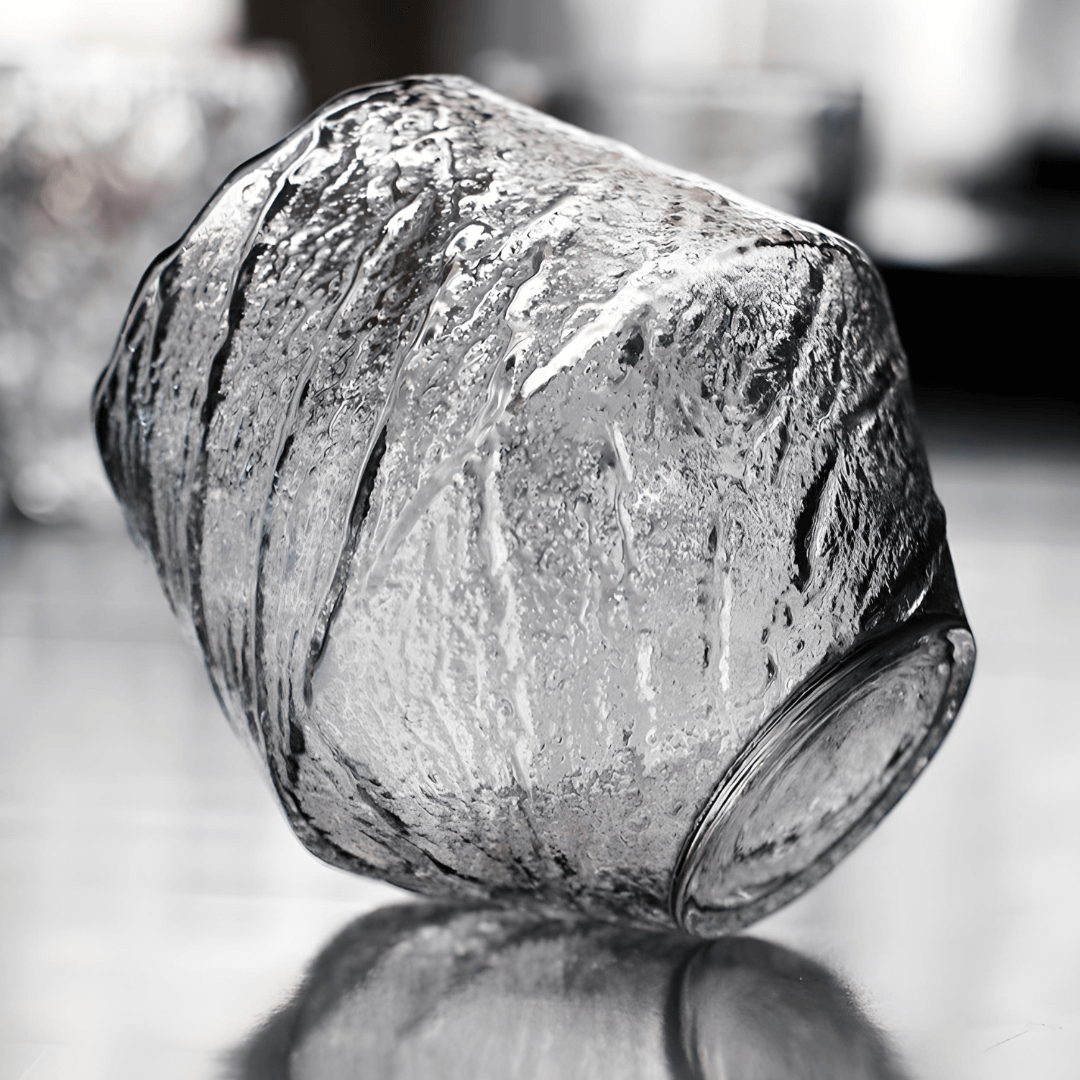 Textured crystal whisky glass, clear finish, faceted irregular surface close-up