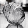 Textured crystal whisky glass, clear finish, faceted irregular surface close-up