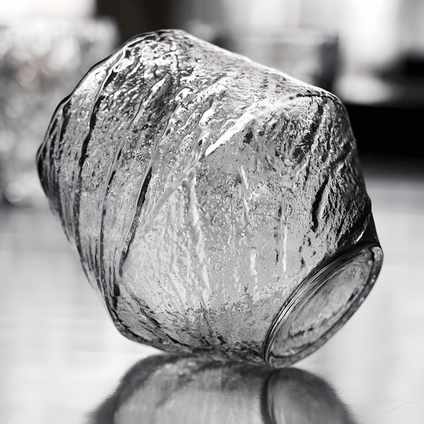 Textured crystal whisky glass, clear finish, faceted irregular surface close-up