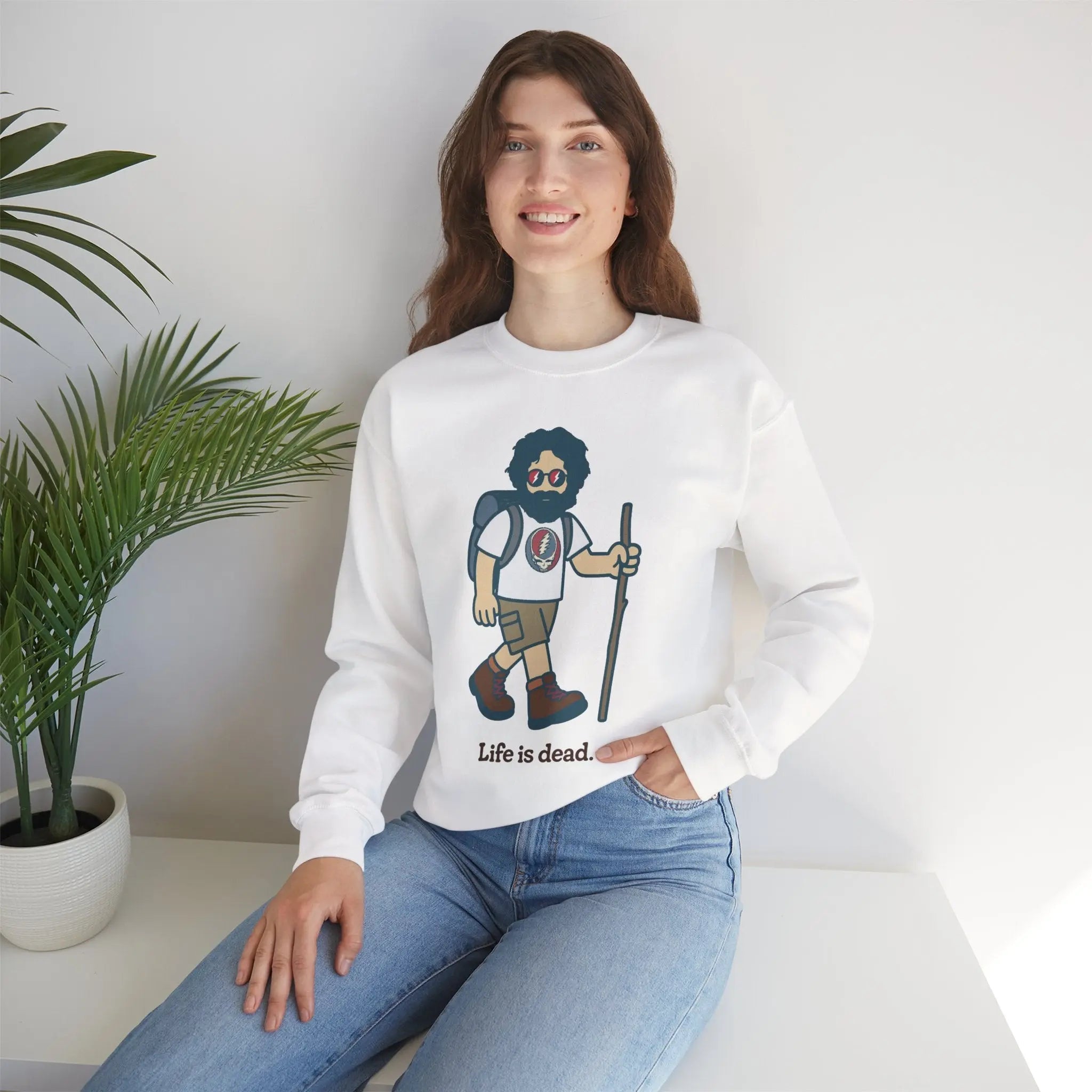 White crewneck sweatshirt on model with bearded hiker graphic and ribbed cuffs