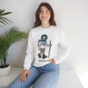 White crewneck sweatshirt on model with bearded hiker graphic and ribbed cuffs