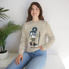 Light sand crewneck sweatshirt with hiker character graphic, worn by model