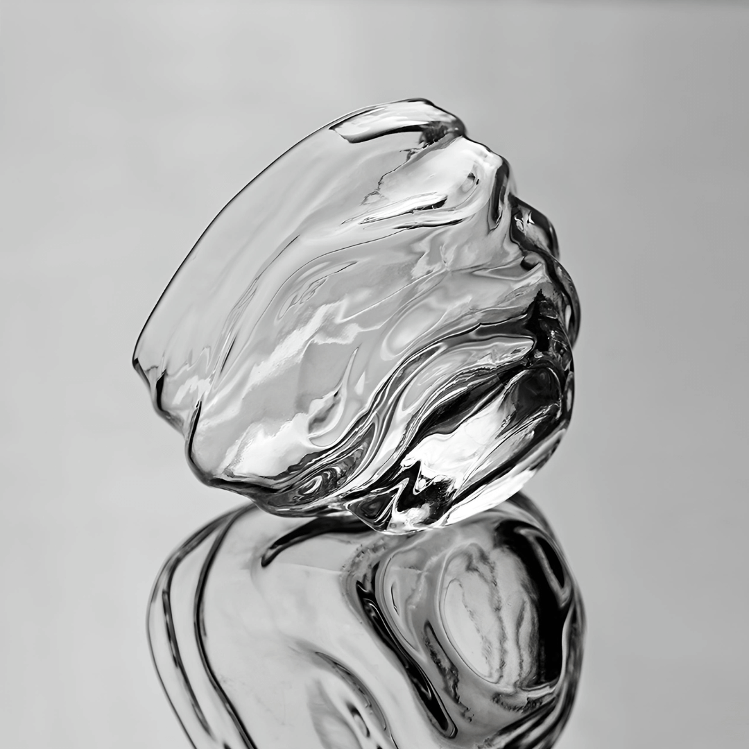 Crystal whisky glass with clear swirling facets, two stacked angles shown.