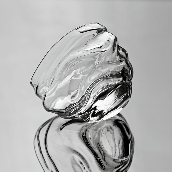 Crystal whisky glass with clear swirling facets, two stacked angles shown.