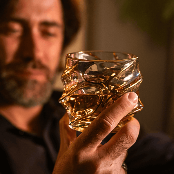 Close-up of Japanese crystal whisky glass with gold line swirl pattern