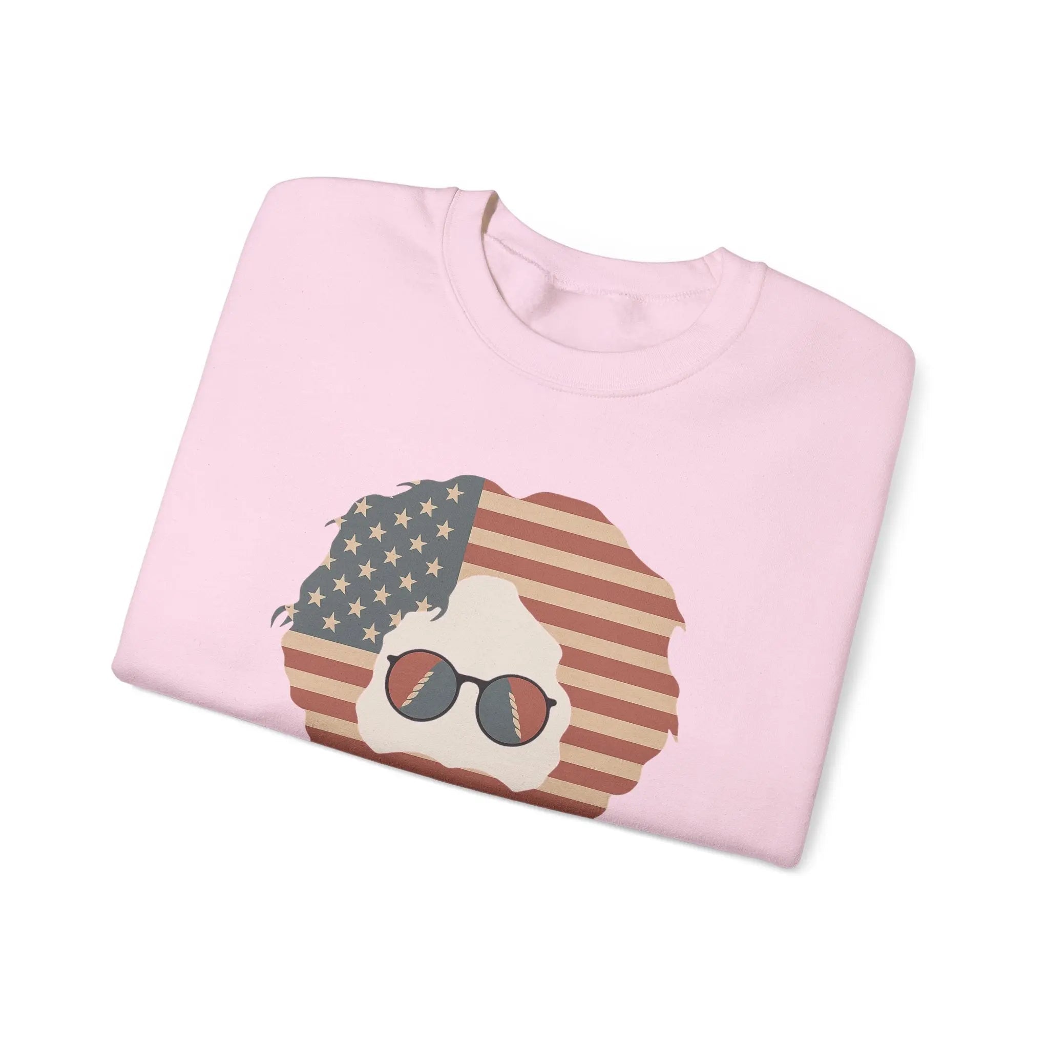 Light pink crewneck sweatshirt with American flag face graphic and sunglasses, folded