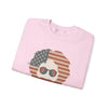 Light pink crewneck sweatshirt with American flag face graphic and sunglasses, folded