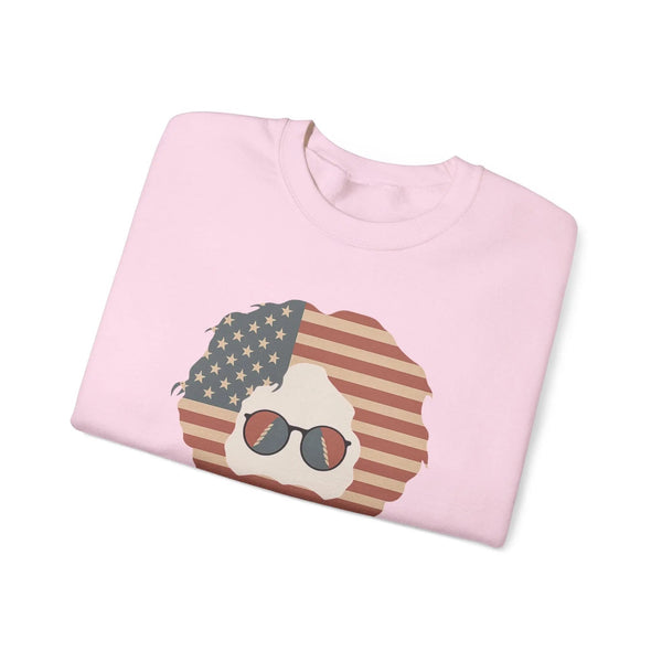 Light pink crewneck sweatshirt with American flag face graphic and sunglasses, folded