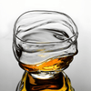 Crystal whisky glass close-up with amber whisky in clear bowl