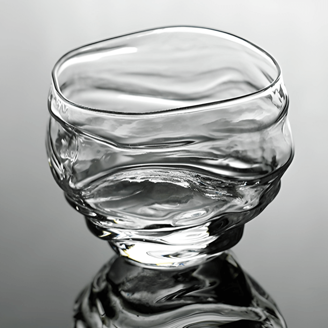 Crystal whisky glass close-up with clear glass and reflective ripples