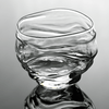 Crystal whisky glass close-up with clear glass and reflective ripples