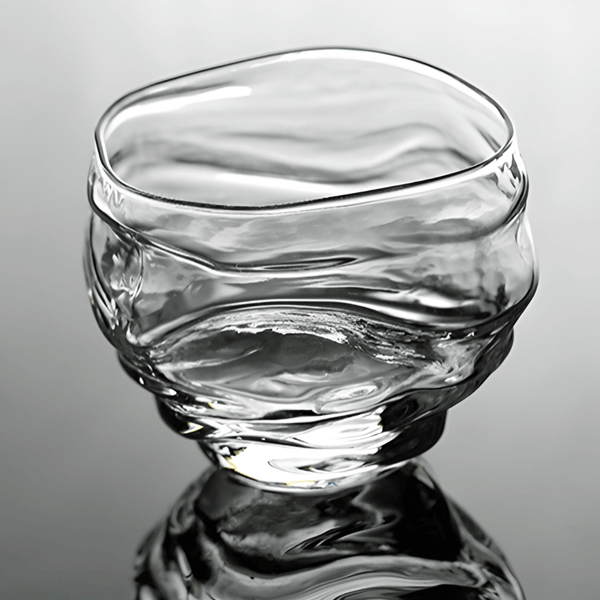 Crystal whisky glass close-up with clear glass and reflective ripples