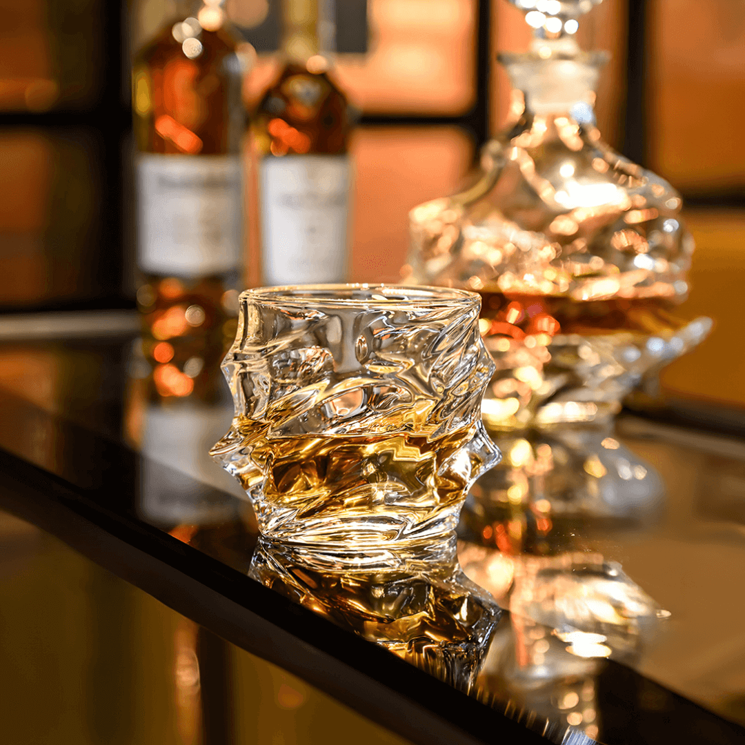 Japanese crystal whisky glass with faceted swirl pattern, holding amber whisky