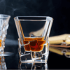Faceted whisky glass with amber liquid, tall rectangular facets